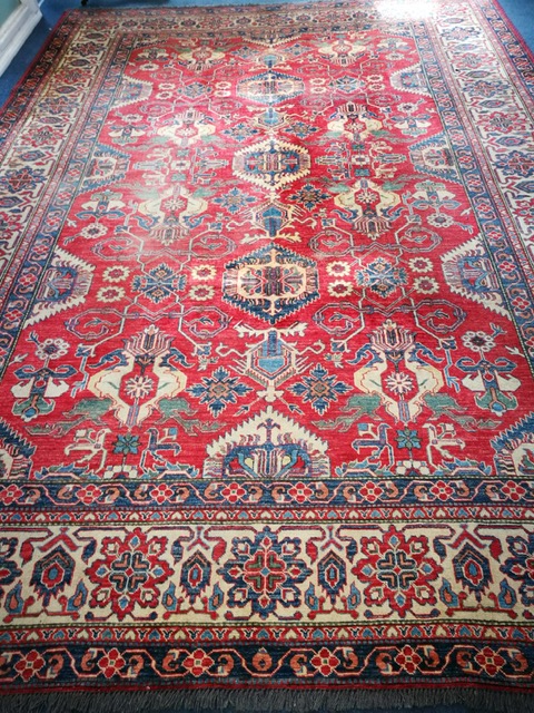 A Caucasian brick red ground carpet 387 x 277cm